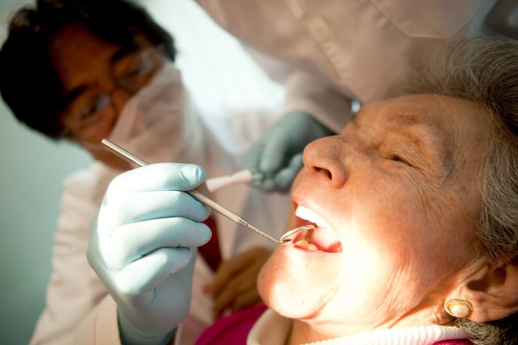 Old woman visiting the dentist taking care of her teeth